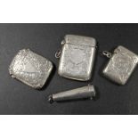 A SILVER CHEROOT HOLDER TOGETHER WITH THREE HALLMARKED SILVER VESTA CASES (4)
