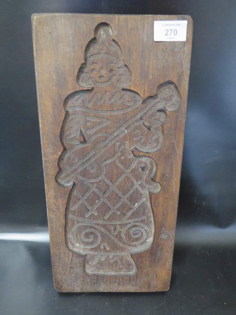 A VINTAGE WOODEN BOOK PRESS WITH THE IMAGE OF A CLOWN