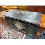 AN ANTIQUE OAK CARVED COFFER WITH MIRROR DETAIL - W 110 CM