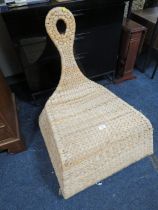 AN UNUSUAL WICKER ROCKING CHAIR