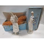 A LLADRO FIGURE OF A DOCTOR HOLDING A NEW BORN BABY TOGETHER WITH A LLADRO FIGURE OF A NURSE IN