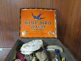 A VINTAGE TIN CONTAINING SEWING ACCESSORIES