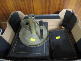 A CANDLE HOLDER WITH EBONY HANDLE IN THE STYLE OF DRESSER STAMPED TO BASE H & H TOGETHER WITH A