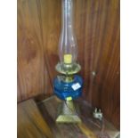 A VINTAGE CONVERTED OIL LAMP WITH BLUE GLASS RESERVOIR