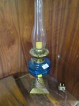 A VINTAGE CONVERTED OIL LAMP WITH BLUE GLASS RESERVOIR