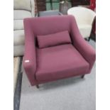 A MODERN MAROON ARMCHAIR