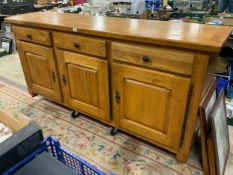 A large and heavy oak sideboard with three drawers above three cupboards W 202 cm