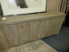 A modern limed three door sideboard W 160 cm