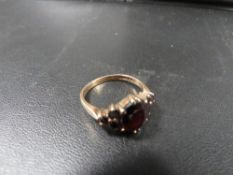 A hallmarked 9 carat gold garnet ring approx weight 3.5