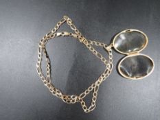 A 375 gold chain approx weight 7.5g together with a gold plated locket