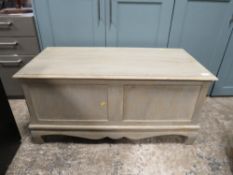 A modern limed blanket box with lift up lid