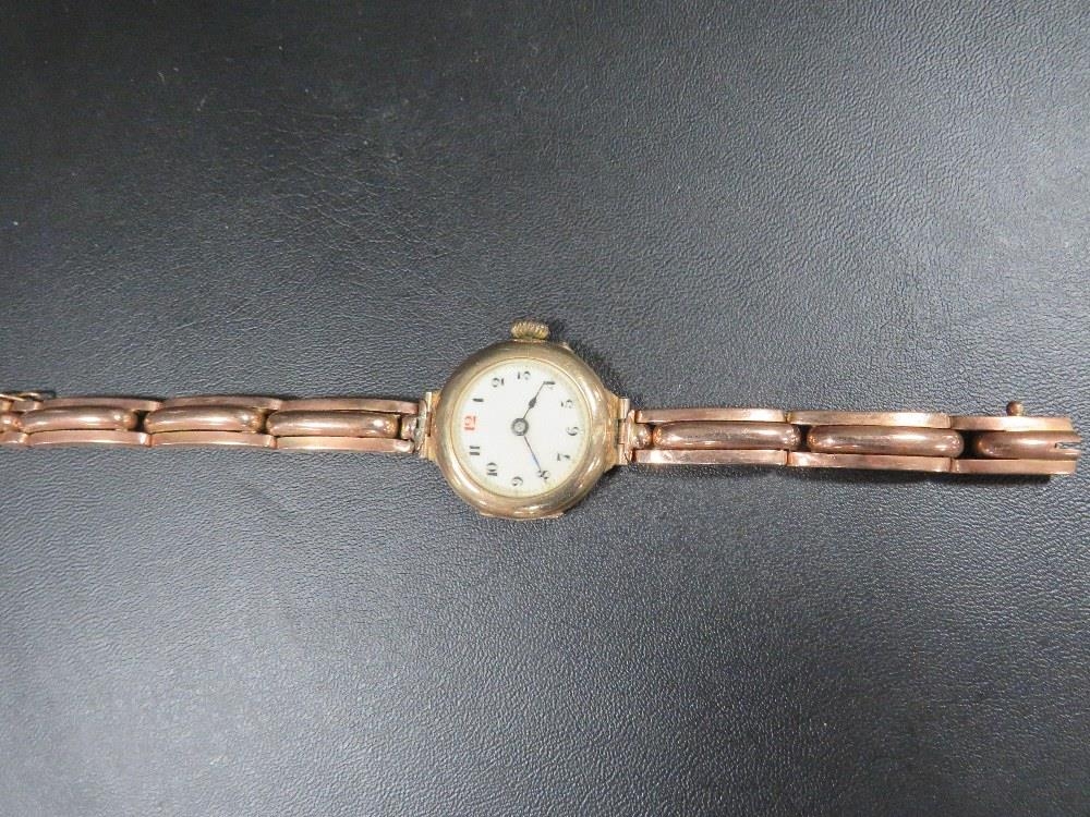 A vintage 9 carat gold watch on expanded plated bracelet