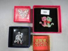 Four boxed Butler & Wilson brooches, two cats, butterfly, three bears and saxophonist