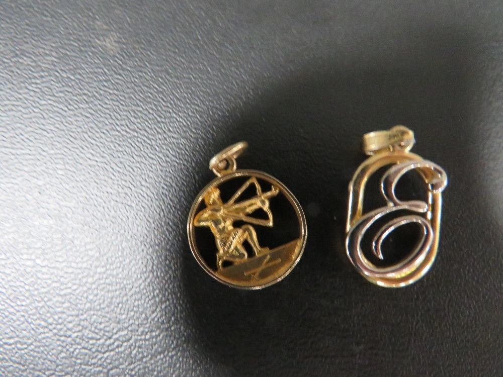 A hallmarked 9 carat gold charm in the form of an archer approx weight 1.8g together with a base - Image 3 of 3