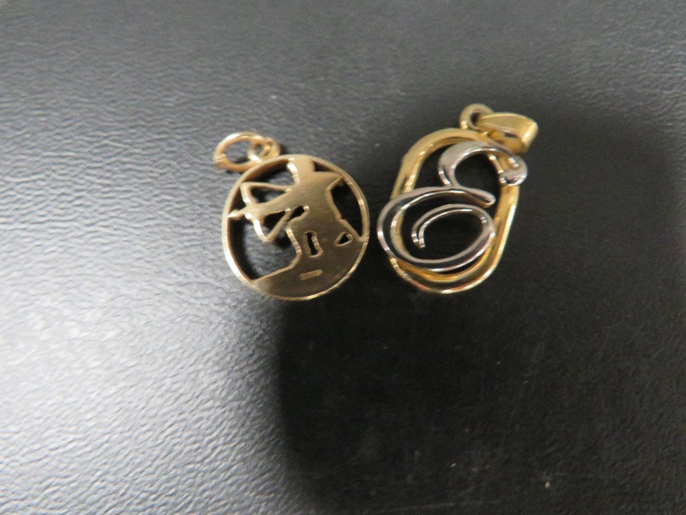 A hallmarked 9 carat gold charm in the form of an archer approx weight 1.8g together with a base