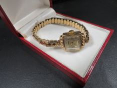 A 9 carat gold rotary wrist watch on a 9 carat gold expandable bracelet
