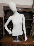 A female half mannequin on stand