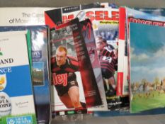 A tray of vintage rugby football programmes to include gold championship and The Queen