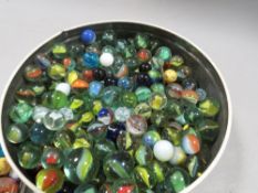 A tin and bag of vintage marbles