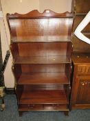 A modern mahogany waterfall bookcase with two drawers below W 76.5 cm