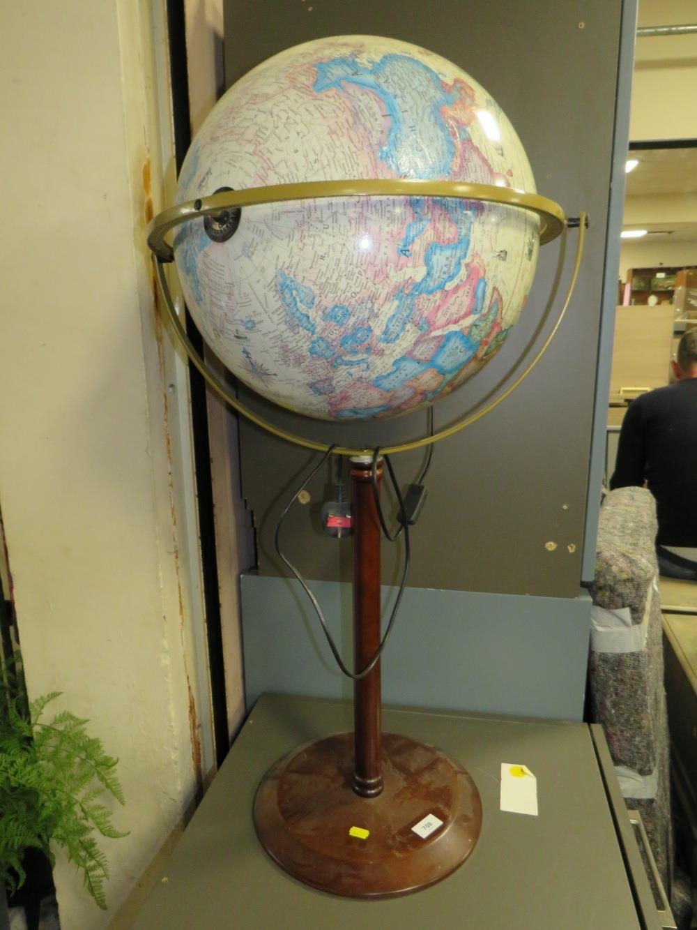 A modern illuminating globe on stand