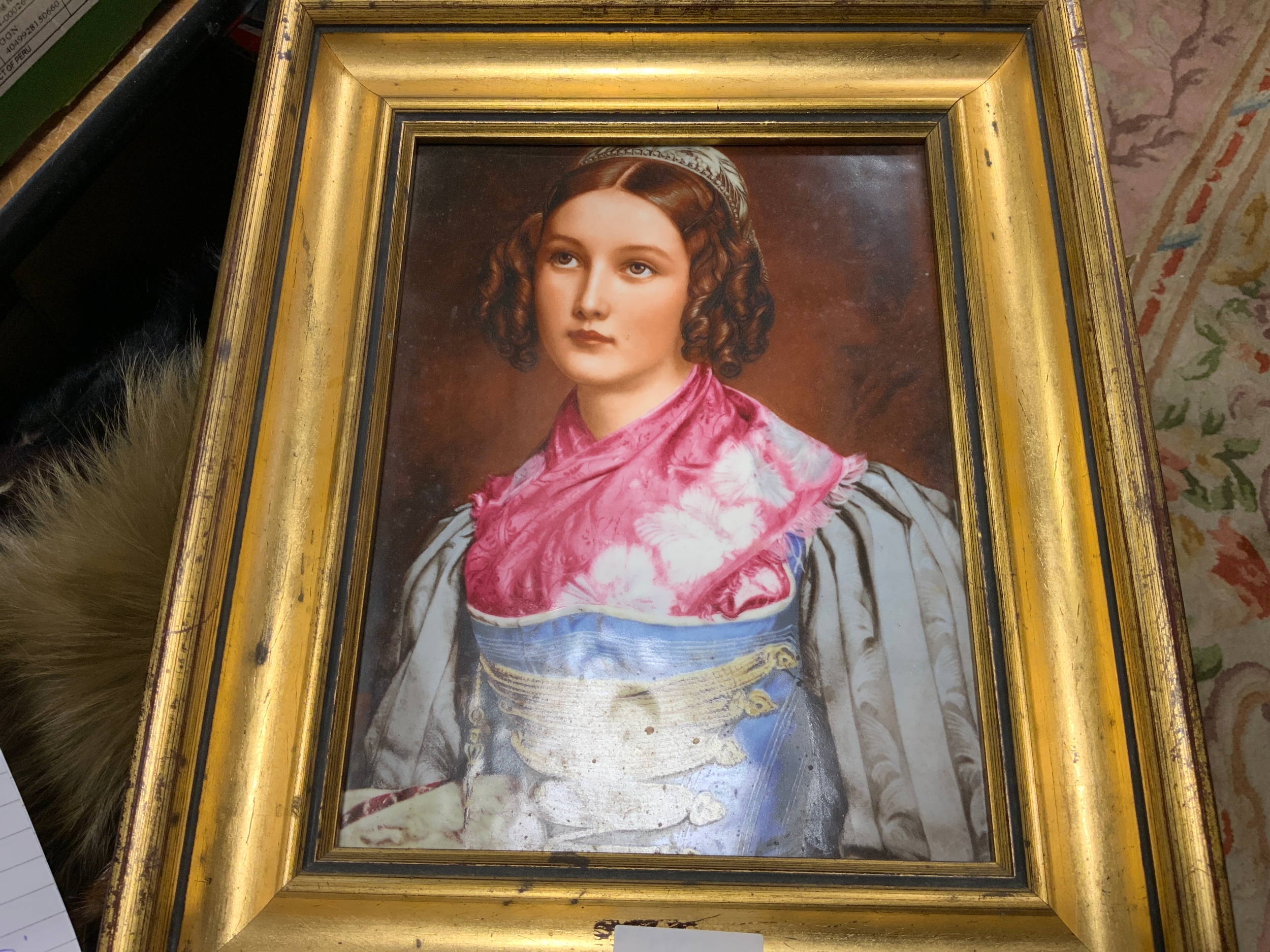 A Continental porcelain plaque depicting a young lady wearing a pink scarf