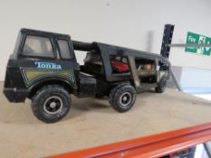A vintage metal Tonka car transporter containing two Tonka cars