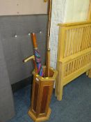 A vintage hexagonal stick stand with assorted sticks to include a hallmark silver top cane