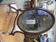 An Edwardian swivel inlaid oval mirror