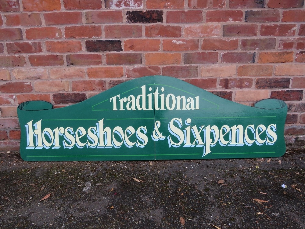 A MODERN FOLDING PAINTED WOOD FAIRGROUND SIGN, inscribed 'Traditional, Horseshoes and Sixpences',