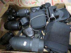 A box of collectable cameras and lenses