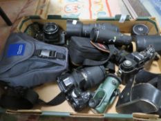 A box of collectable cameras and lenses