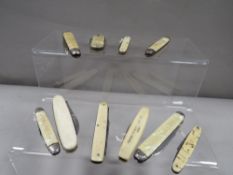 A collection of mother of pearl / bone pocket knives