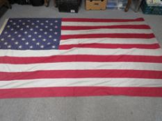 A large vintage U.S.A. stars & stripes flag having 50 sewn stars, approx 8ft x 5ft