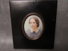 A LATE 19TH / EARLY 20TH CENTURY PORTRAIT MINIATURE, study of a lady in a blue bonnet, oval, 6.5 x 5