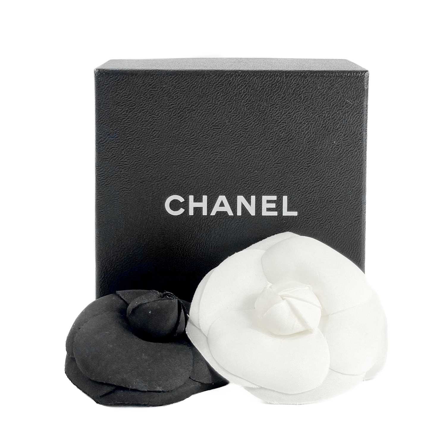Two 1980s Chanel camellia fabric flower brooches.