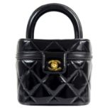 A Chanel Matelasse patent black leather CC vanity bag.