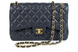 A Chanel maxi navy blue caviar leather handbag.