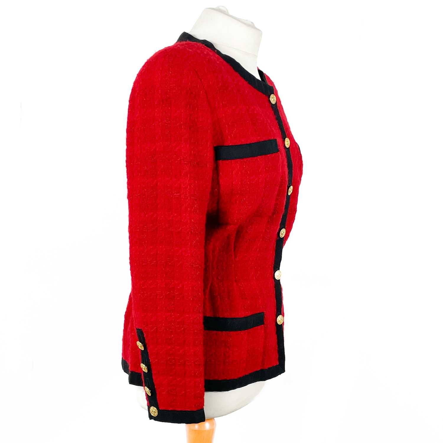 A Chanel 1980's red boucle jacket with gold plated buttons and black trim. - Image 3 of 9
