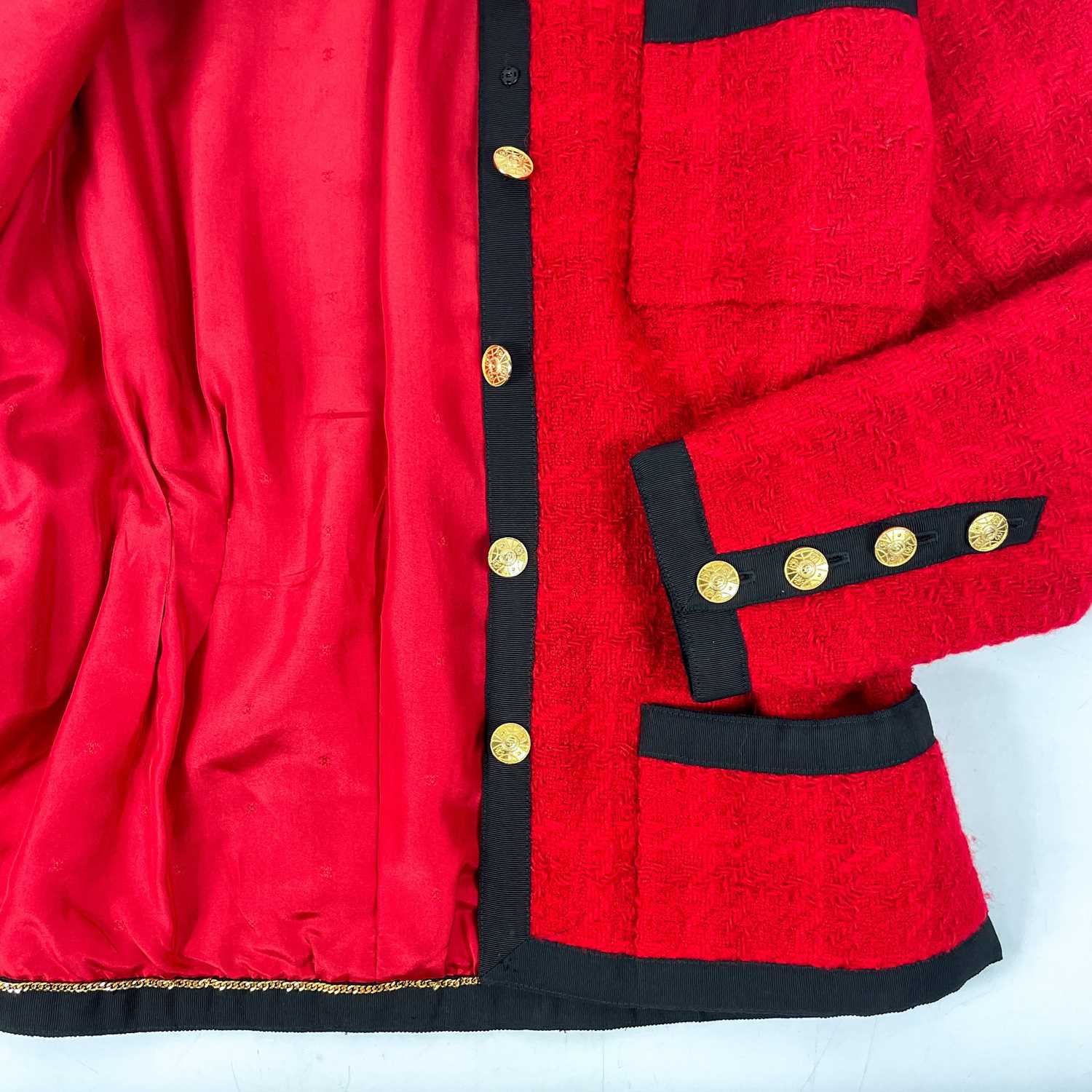 A Chanel 1980's red boucle jacket with gold plated buttons and black trim. - Image 6 of 9