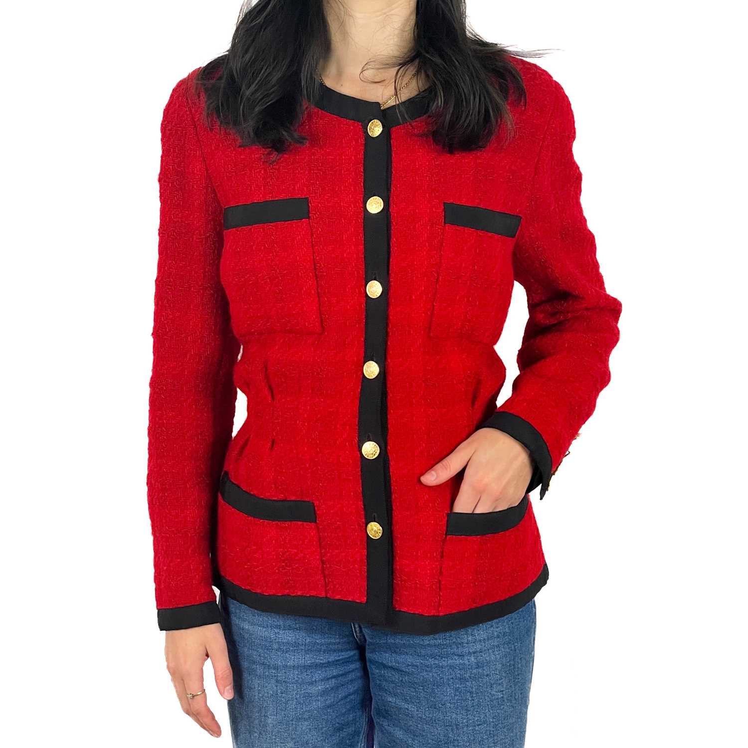 A Chanel 1980's red boucle jacket with gold plated buttons and black trim.