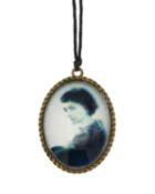 A Chanel Runway oval photo pendant necklace with a photograph of Coco Chanel.