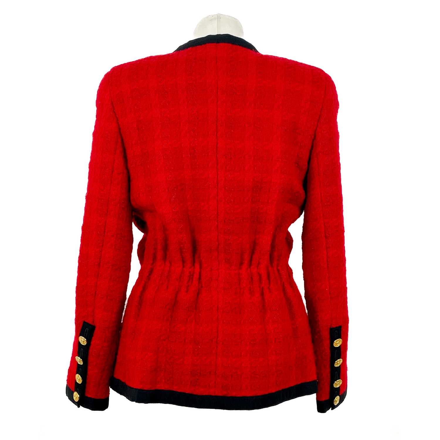 A Chanel 1980's red boucle jacket with gold plated buttons and black trim. - Image 4 of 9