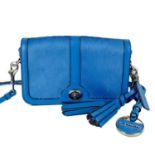 A blue Coach leather and calf hair turn lock crossbody bag.