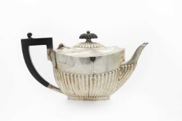 A Victorian silver half-fluted bachelor teapot by James Dixon & Son.