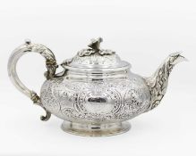 An early Victorian silver foliate scroll embossed and chased teapot by Charles Gordon.