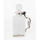 An Edwardian Betjemann's patent silver mounted cut glass locking decanter.