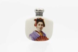 A silver lidded ceramic scent bottle decorated with a Geisha girl.