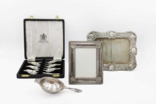 A silver photo frame by William Neale.