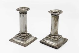 A pair of George V silver candlesticks by William Neale.